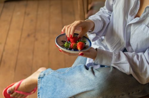 Fresh strawberries served in a ceramic bowl, capturing a simple and healthy lifestyle moment in a rustic countryside setting.
